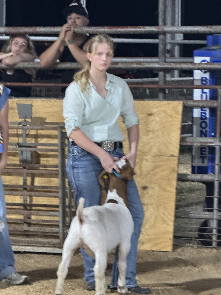 student holding goat at FFA showing
