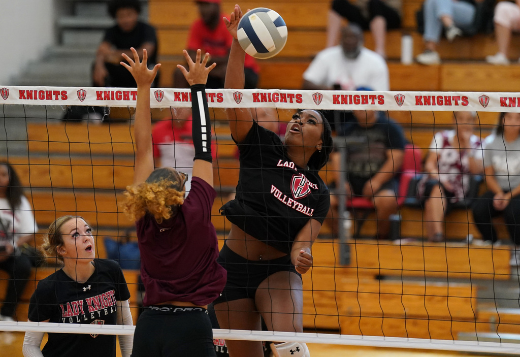 HHHS volleyball players spikes the ball