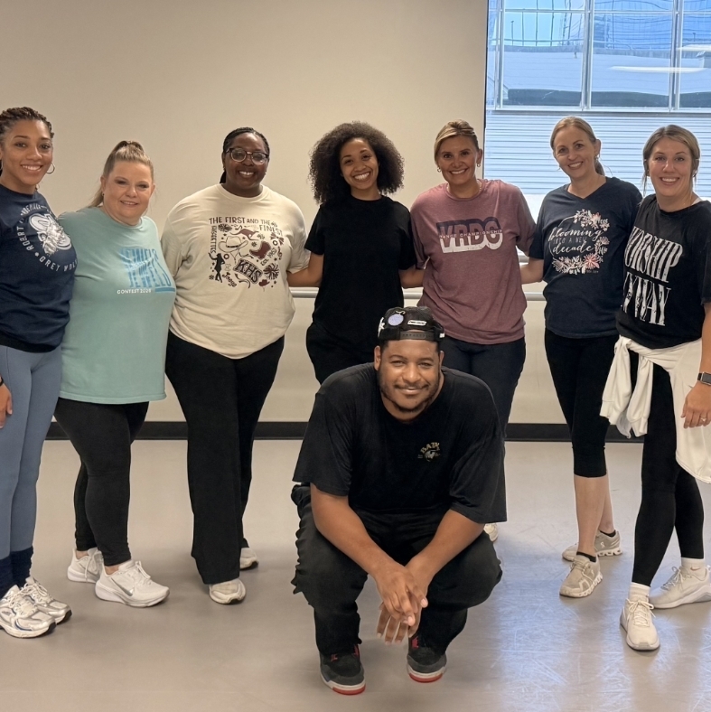 Eight dancers in a studio