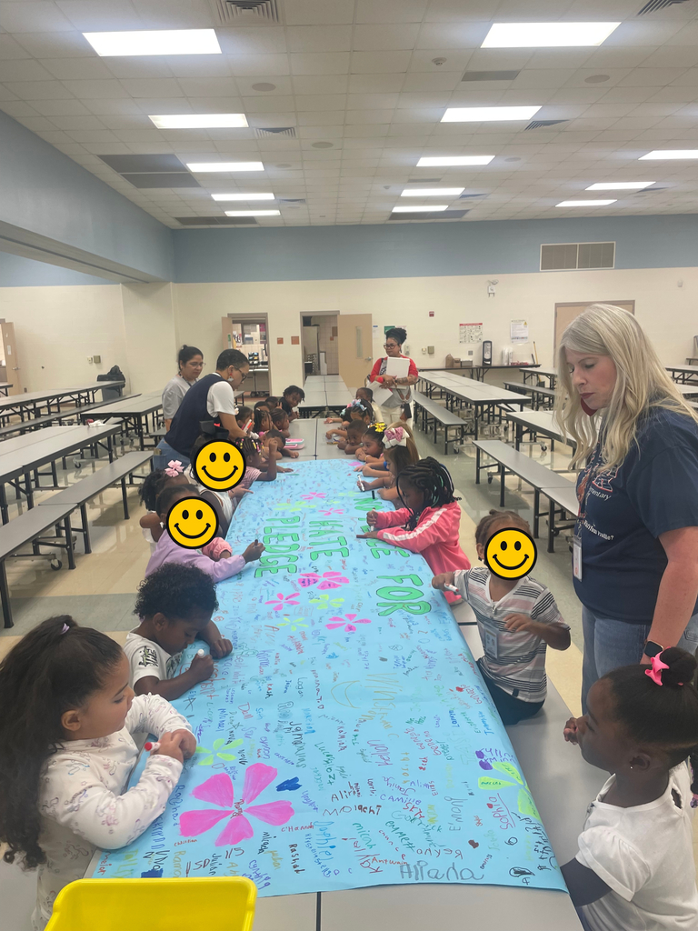 Pre-K students signing the no place for hate banner