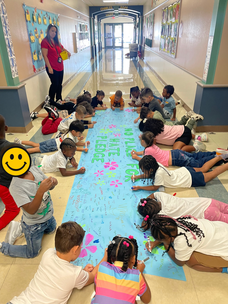 Kinder signing the no place for hate banner
