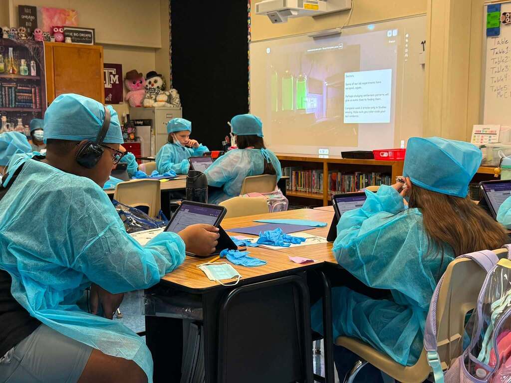 students in scrubs working on their lessons