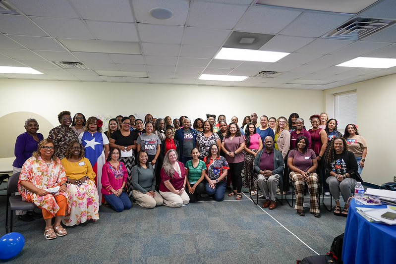 group photo of a larger group smiling people