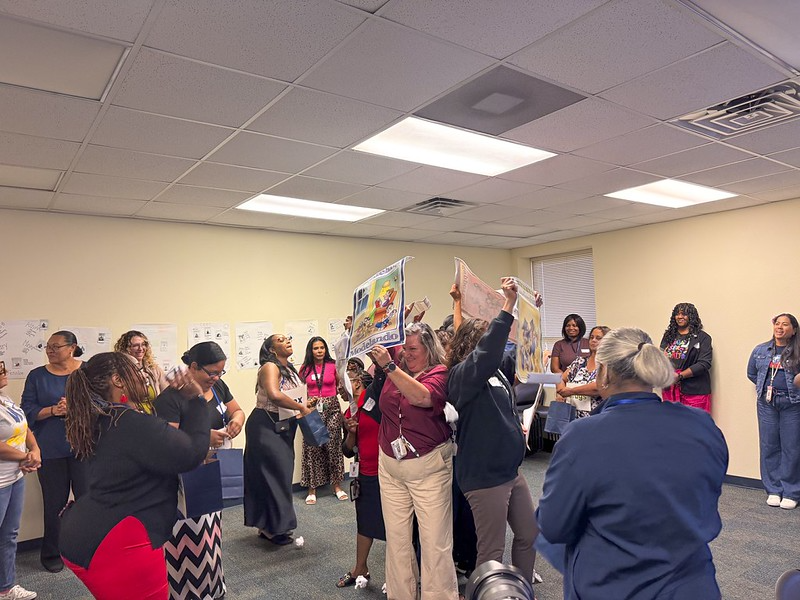 people in a circle with a poster