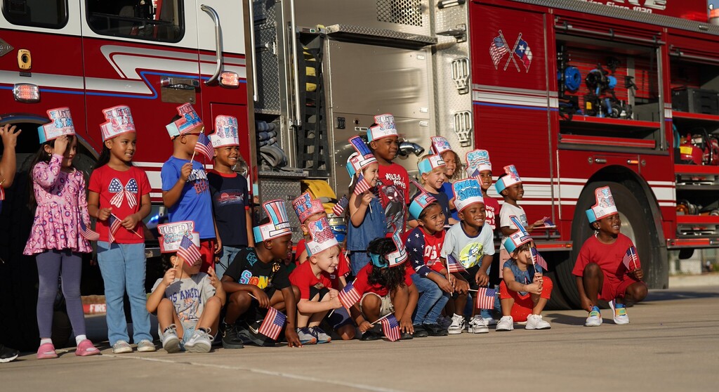 group of students in front of a firetruck smiling
