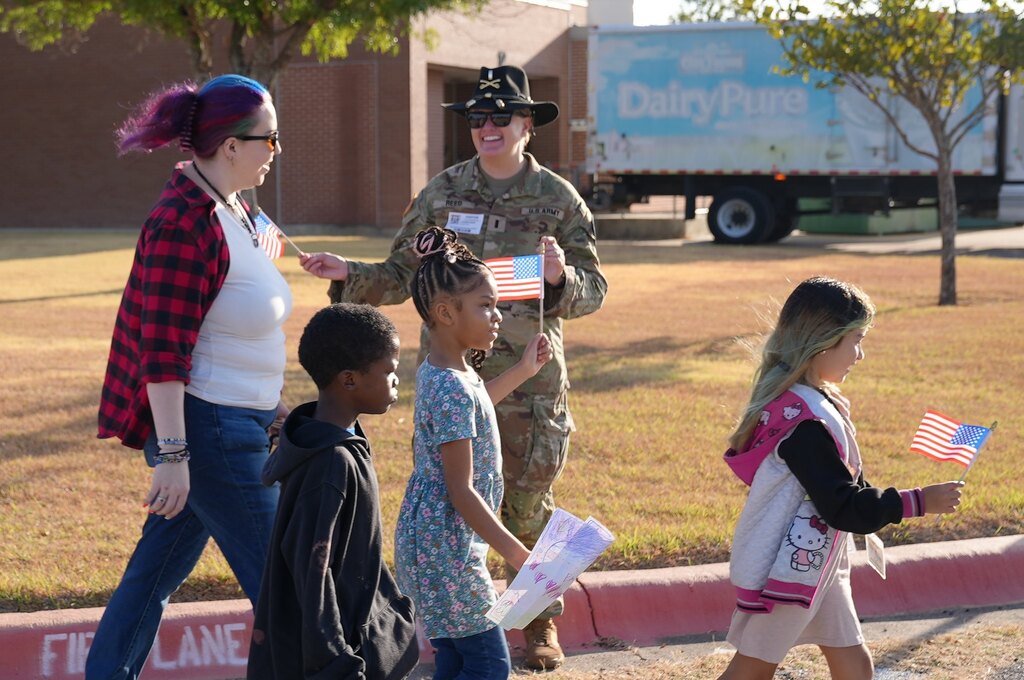 students walking holding their flags