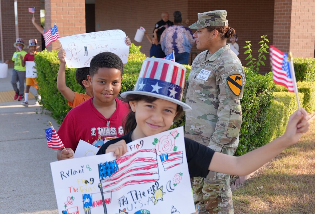 students walking holding their flags