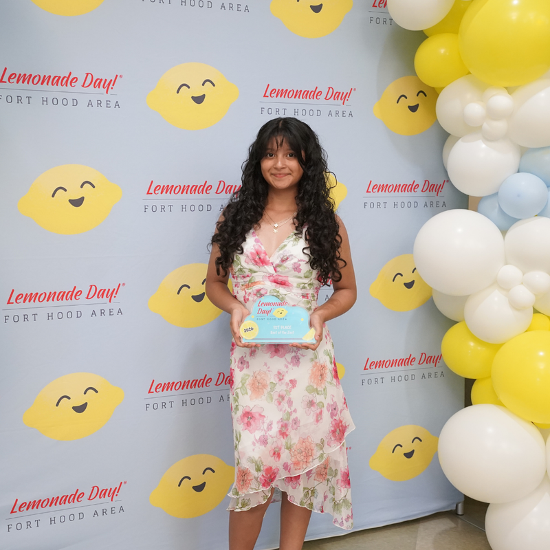 photo of girl holding award and smiling at the camera