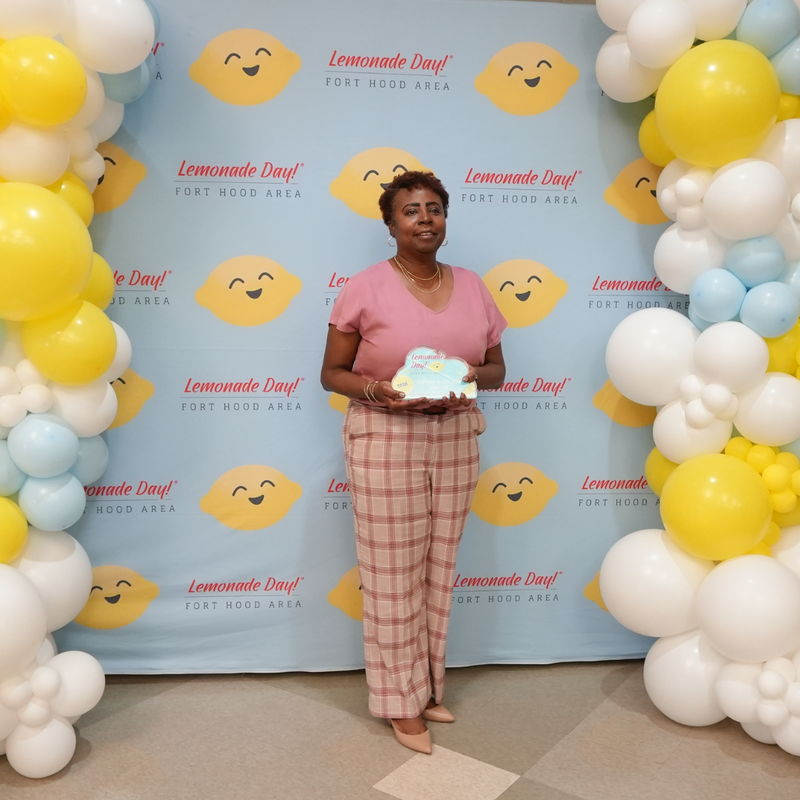 woman holding award smiling at camera