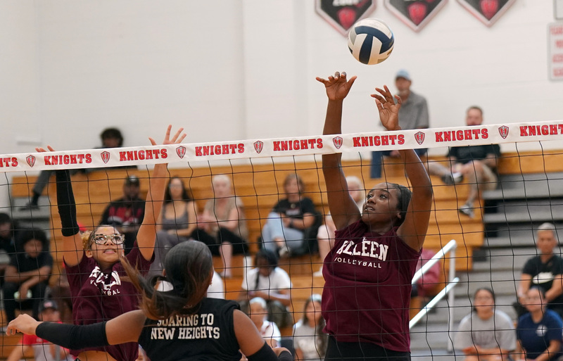 Volleyball player blocks at the net