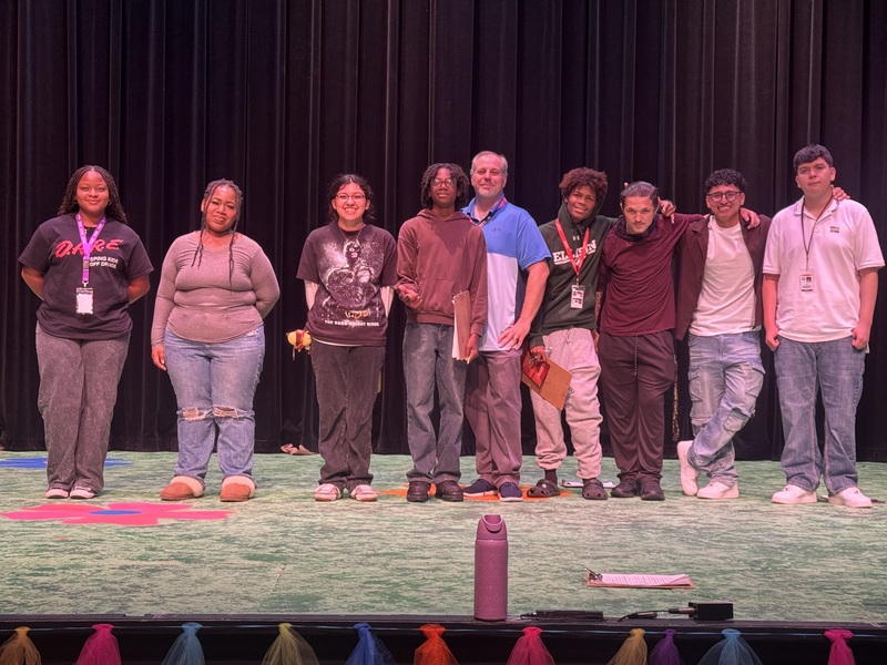 group photoo of students with mr. griffin on stage