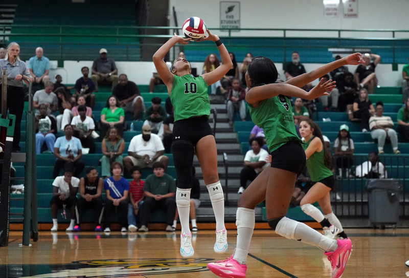 Ellison volleyball player sets the ball