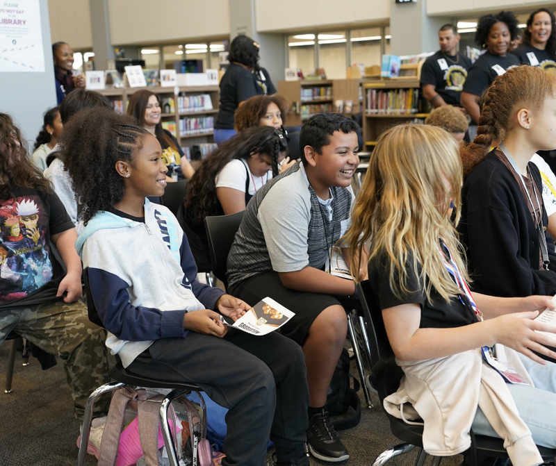 kids sitting down smiling and excited