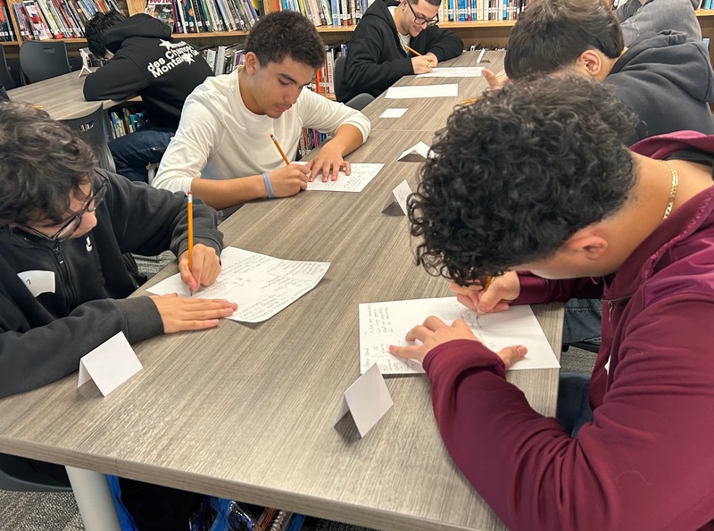 students looking down at their pieces of paper working 