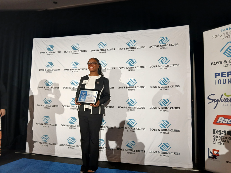 girl holding award smiling