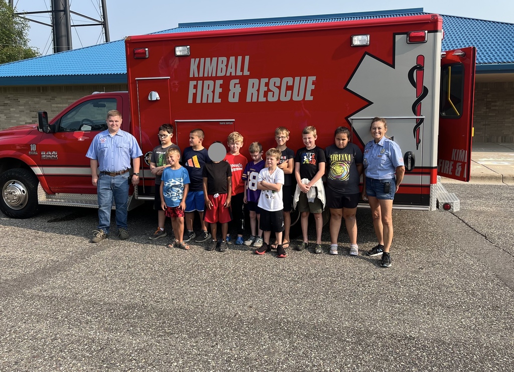 students in front of fire and rescue truck