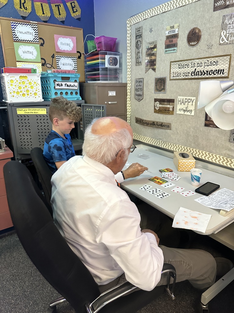 student playing cards with grandfather