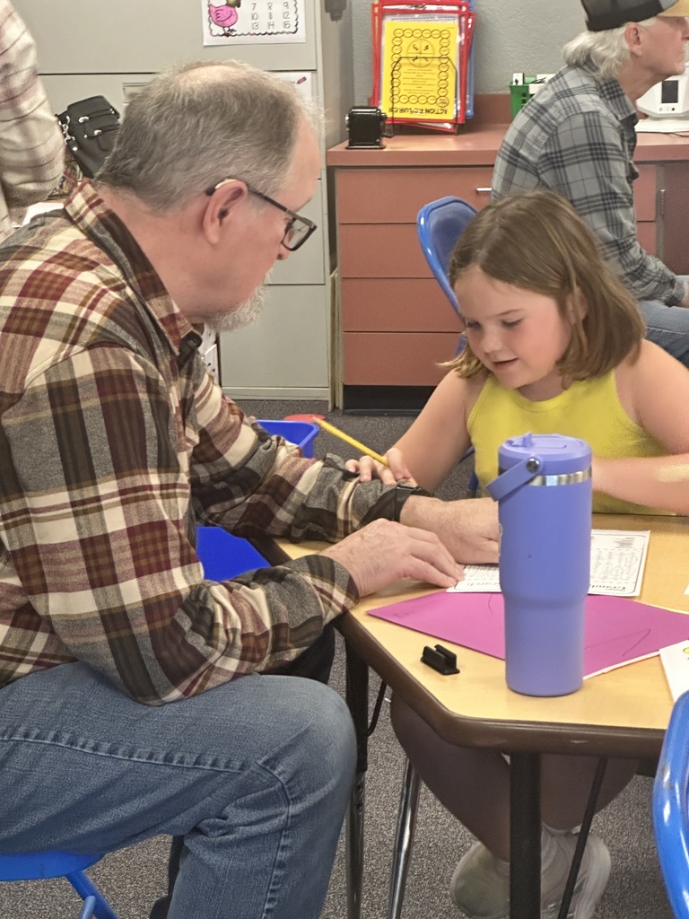 student doing a crossword puzzle with grandparent