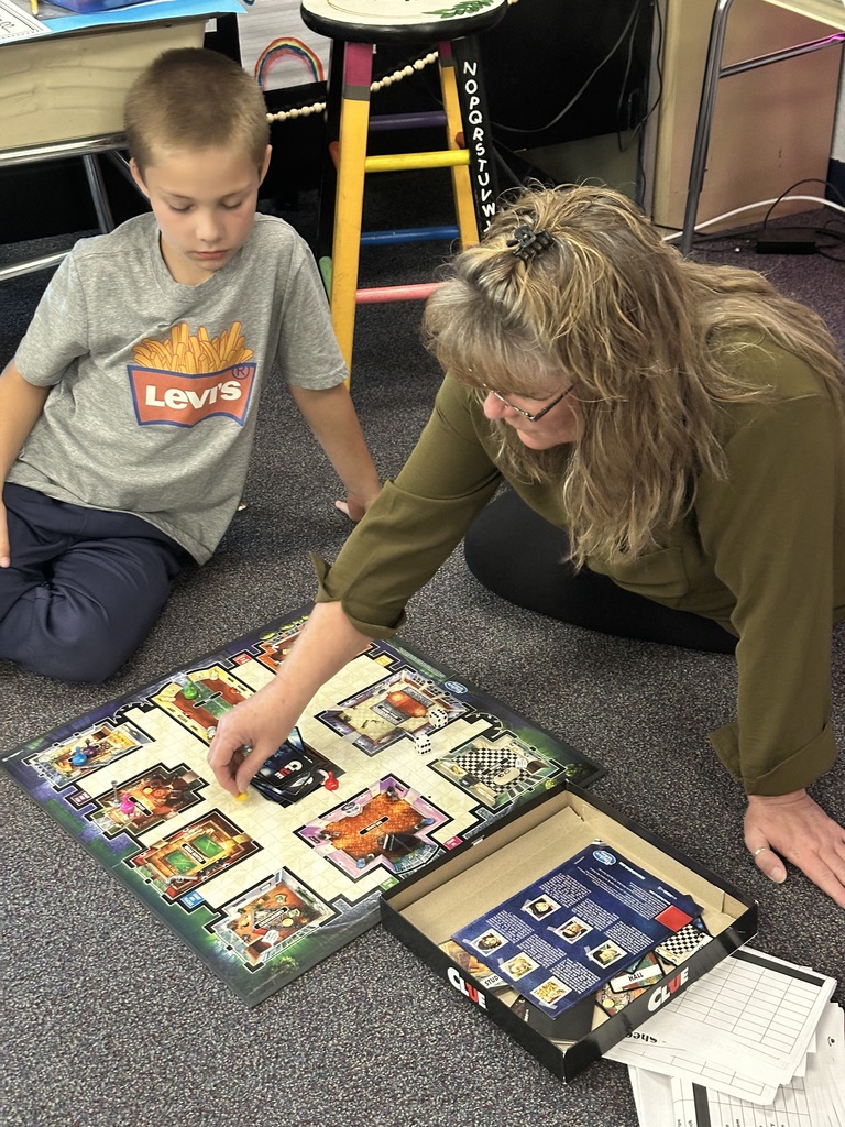 grandparent playing a game on the floor with student