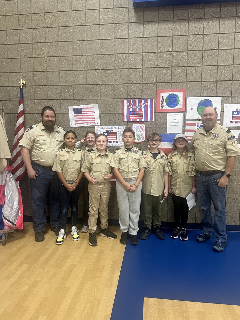 cubs scouts and leaders with flag