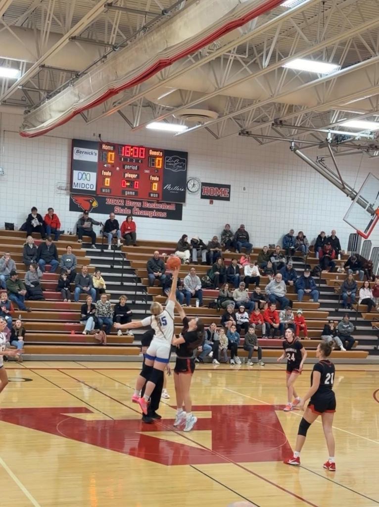 Girls baskteball players going up for a rebound