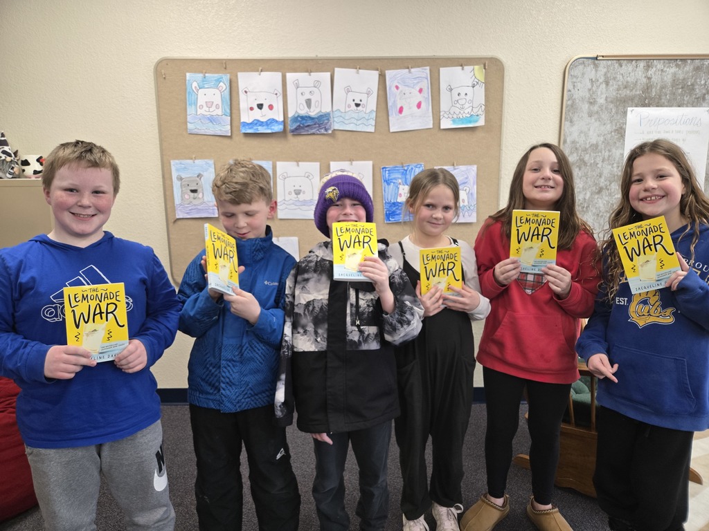 students holding books