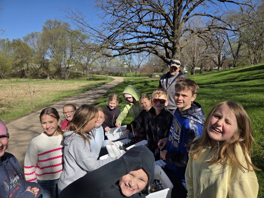 group photo of students outside with tree and path in background