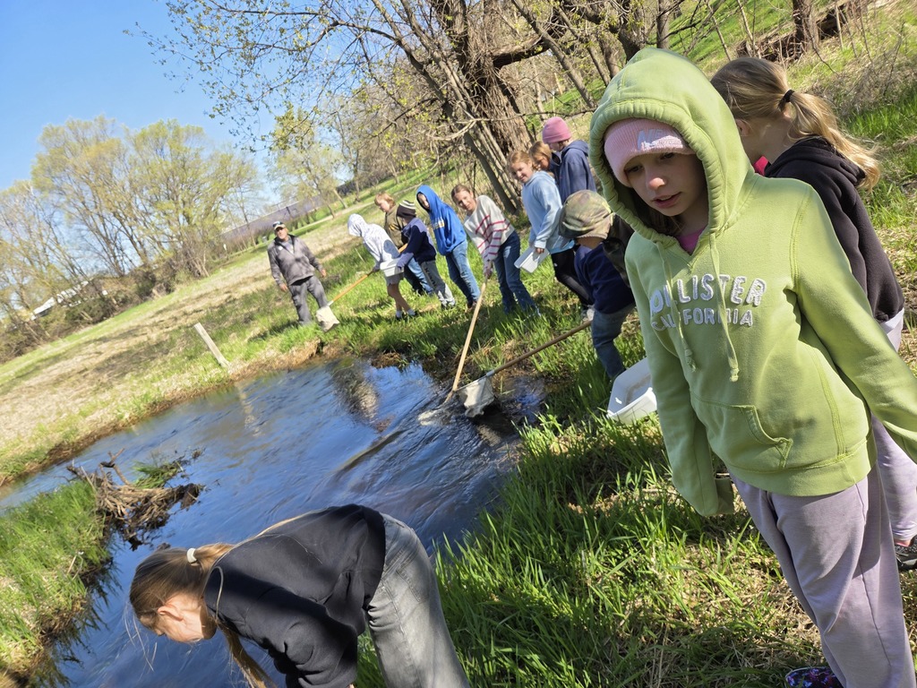 students collecting water from pond
