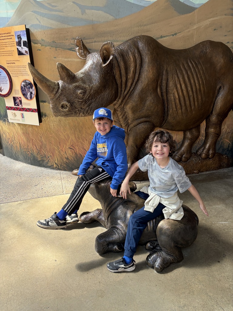 2 biys on rhino statue