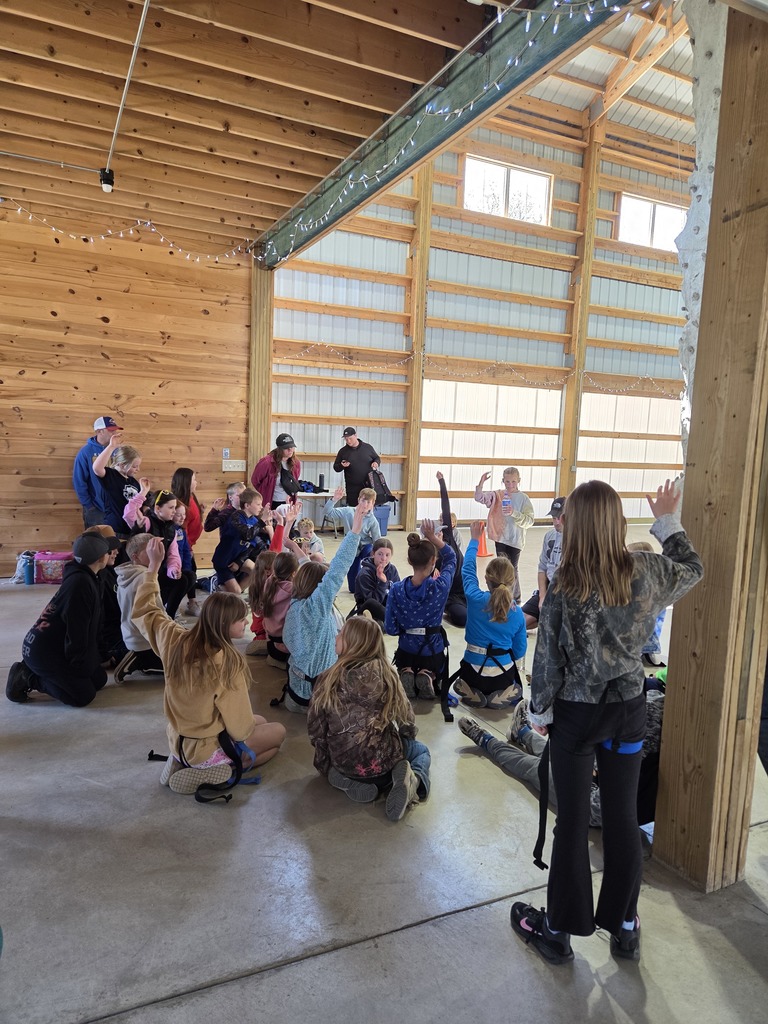 group photo of students in shed listening to speakers