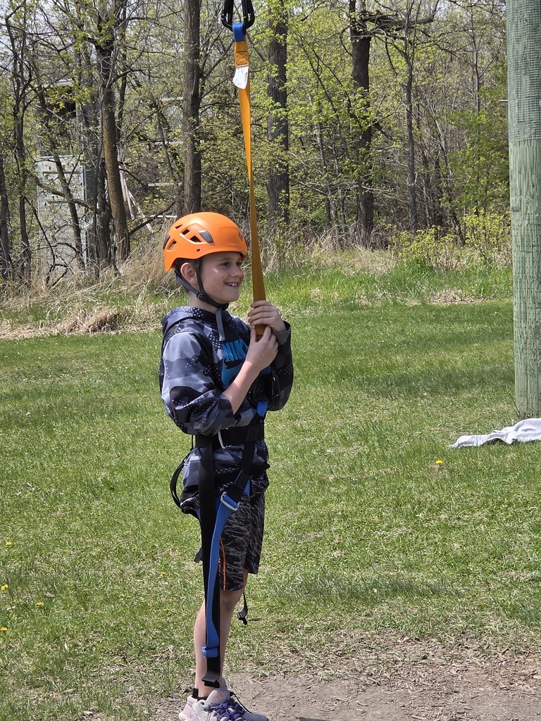 student in harness for zipline