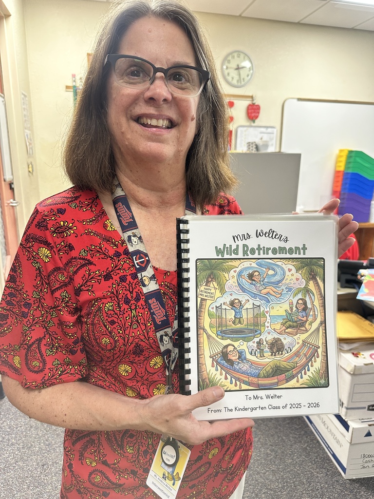 Teacher holding a book about her retirement