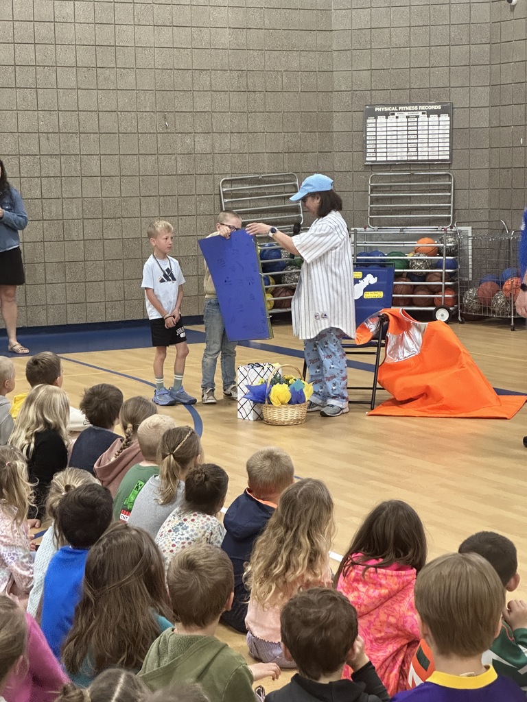 students giving ms. welter gifts and a giant card