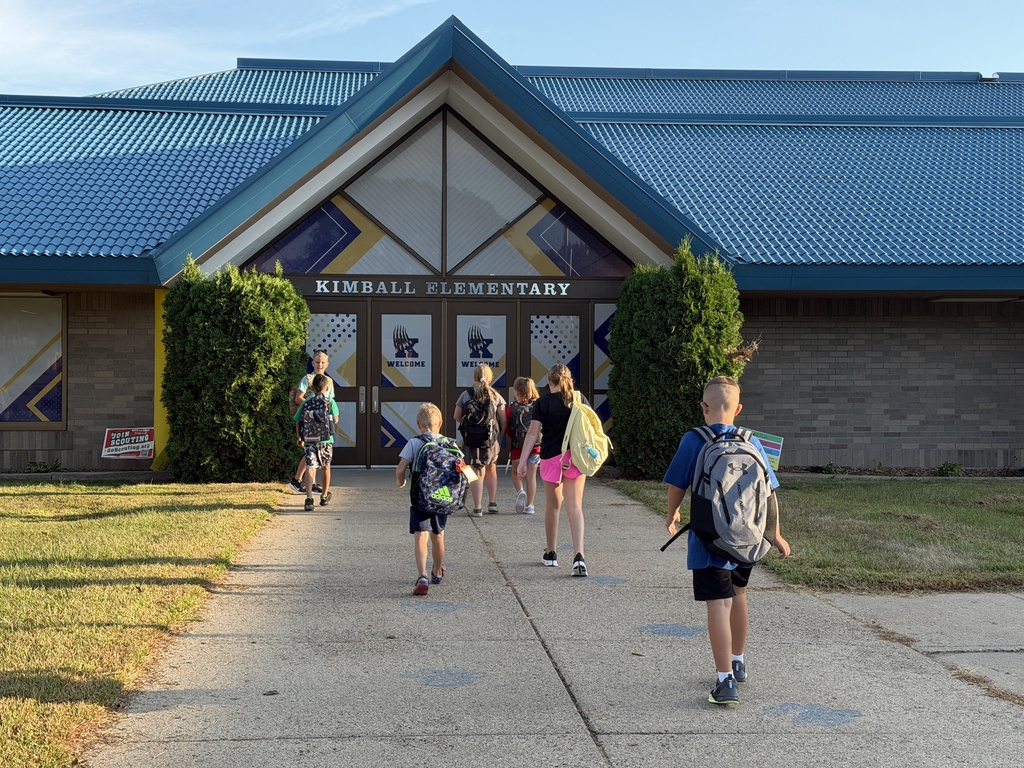 students walking toward front doors of school