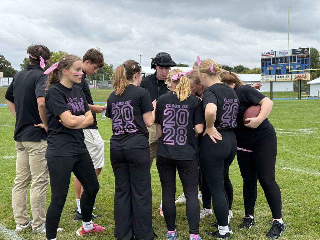 Junior girls in a football huddle