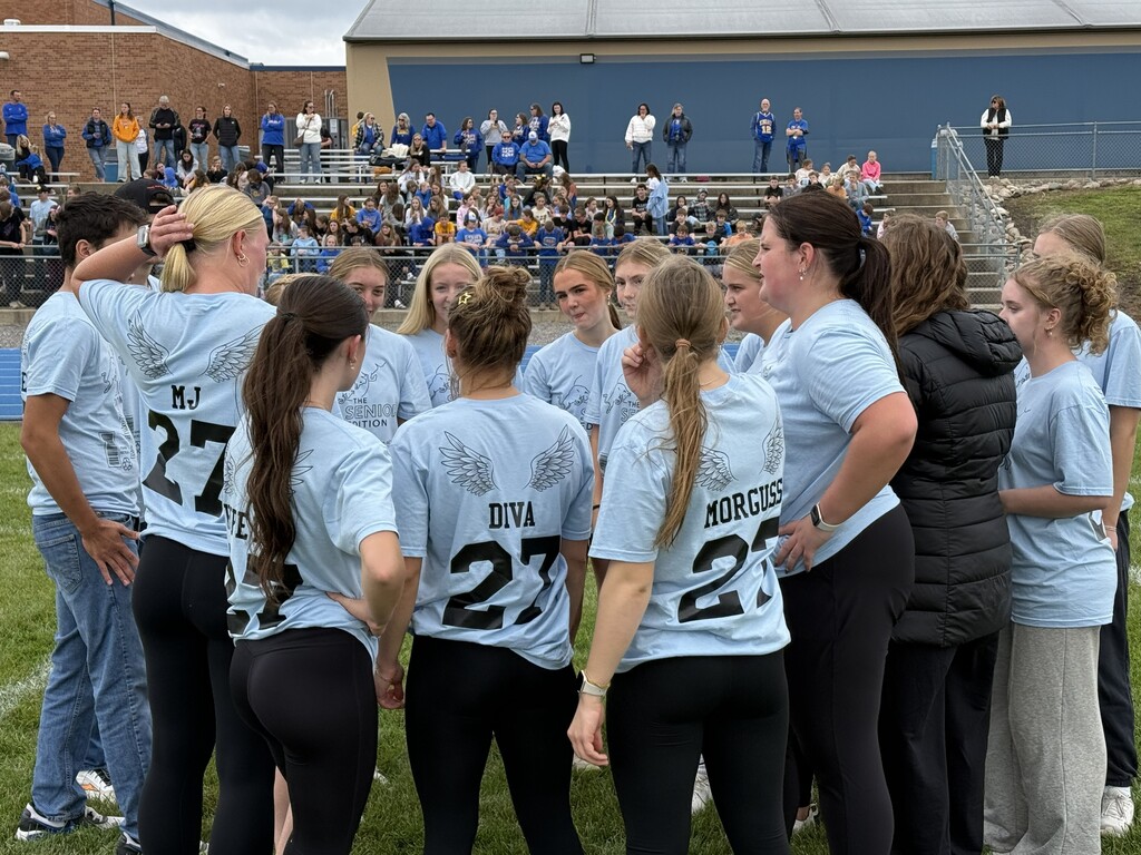 Senior Girls in a football huddle during Powderpuff game