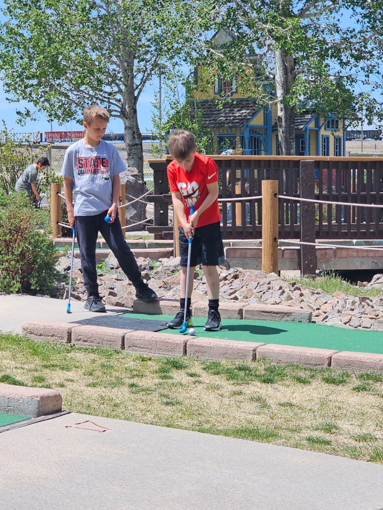 two boys golfing 