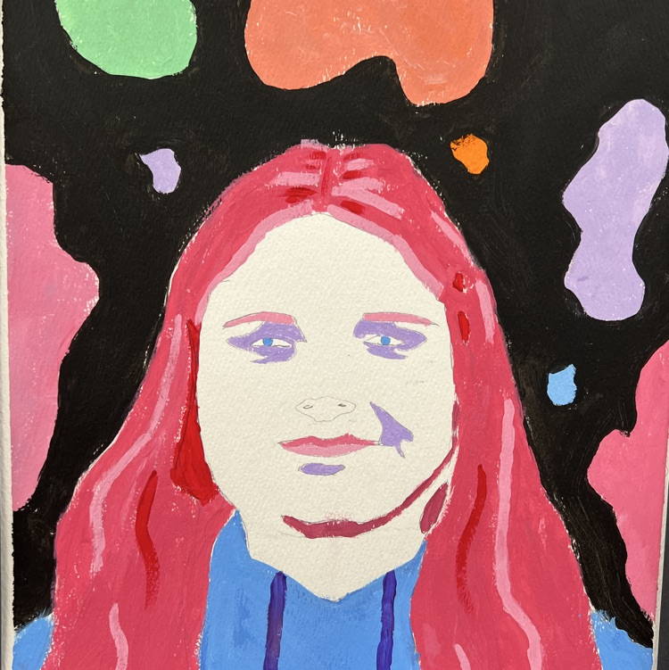 Portrait of a person with red hair and blue eyes against a colorful, abstract background.