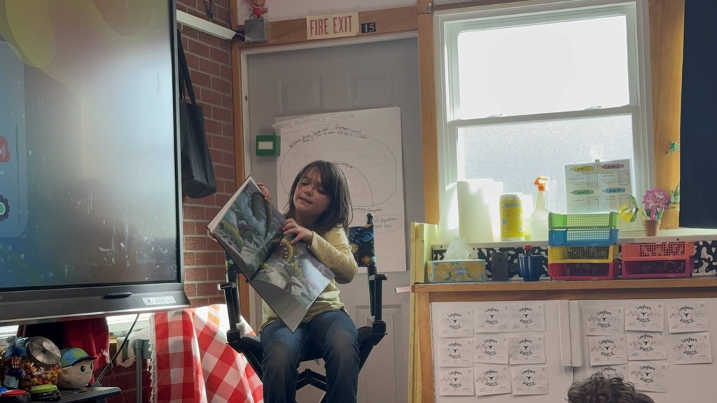 Girl reading a book in a classroom