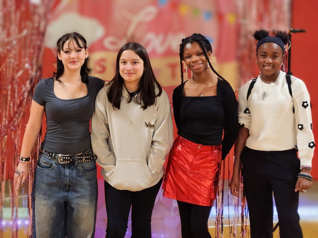 Four girls smiling together.