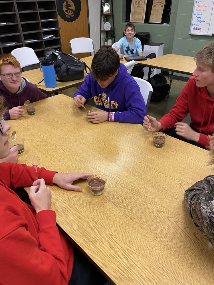 Ag Science II constructing their dirt in a cup to learn about soil horizons.