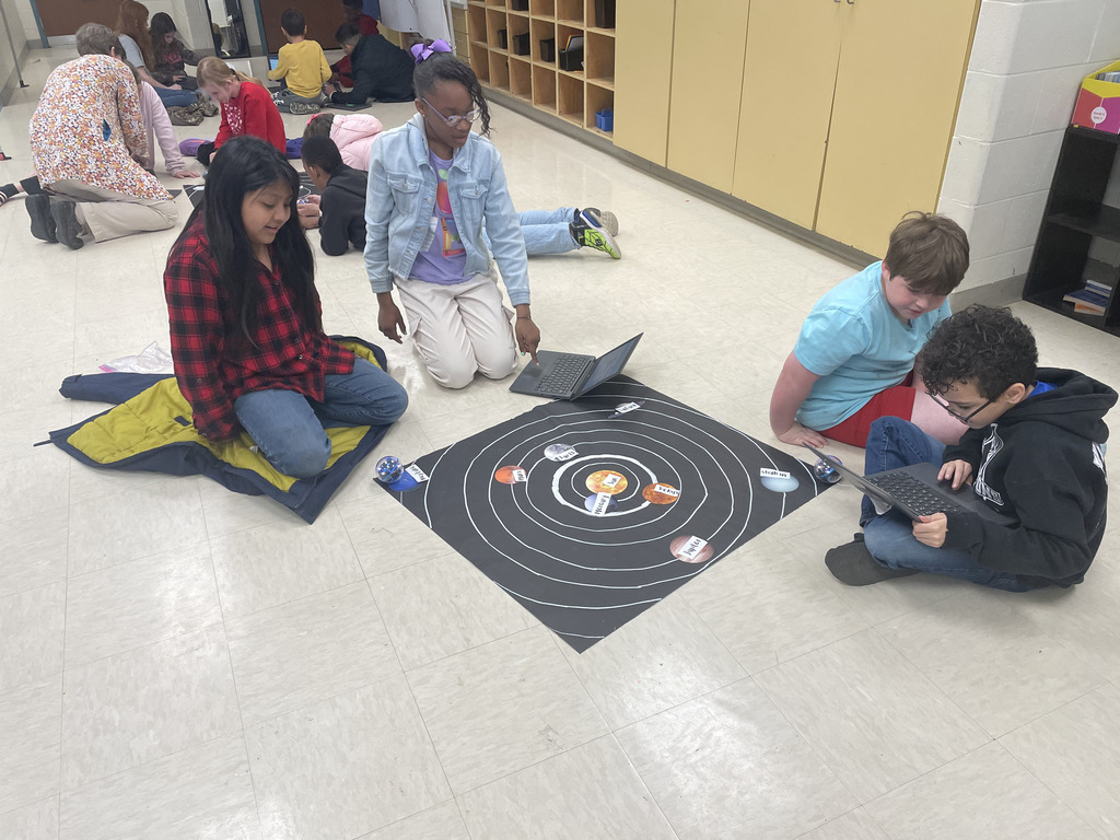 Students exploring the solar system through technology.
