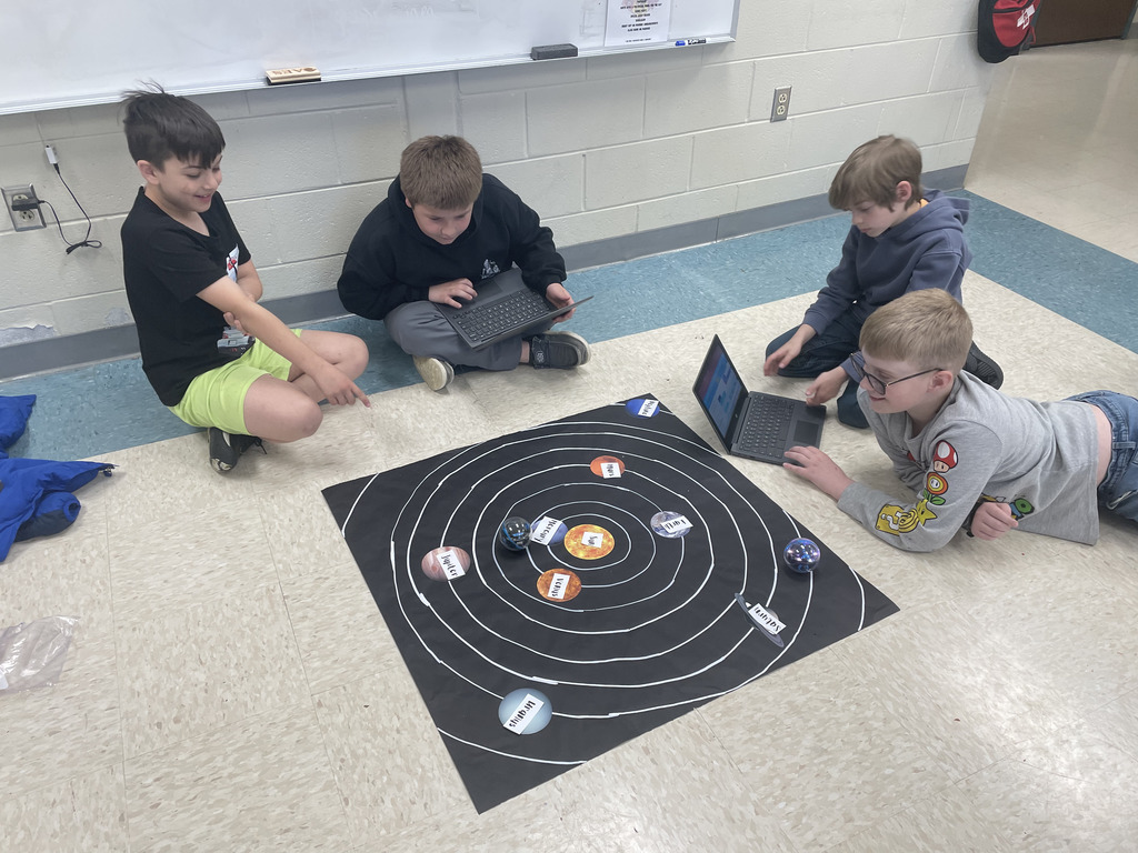 Students exploring the solar system through technology.