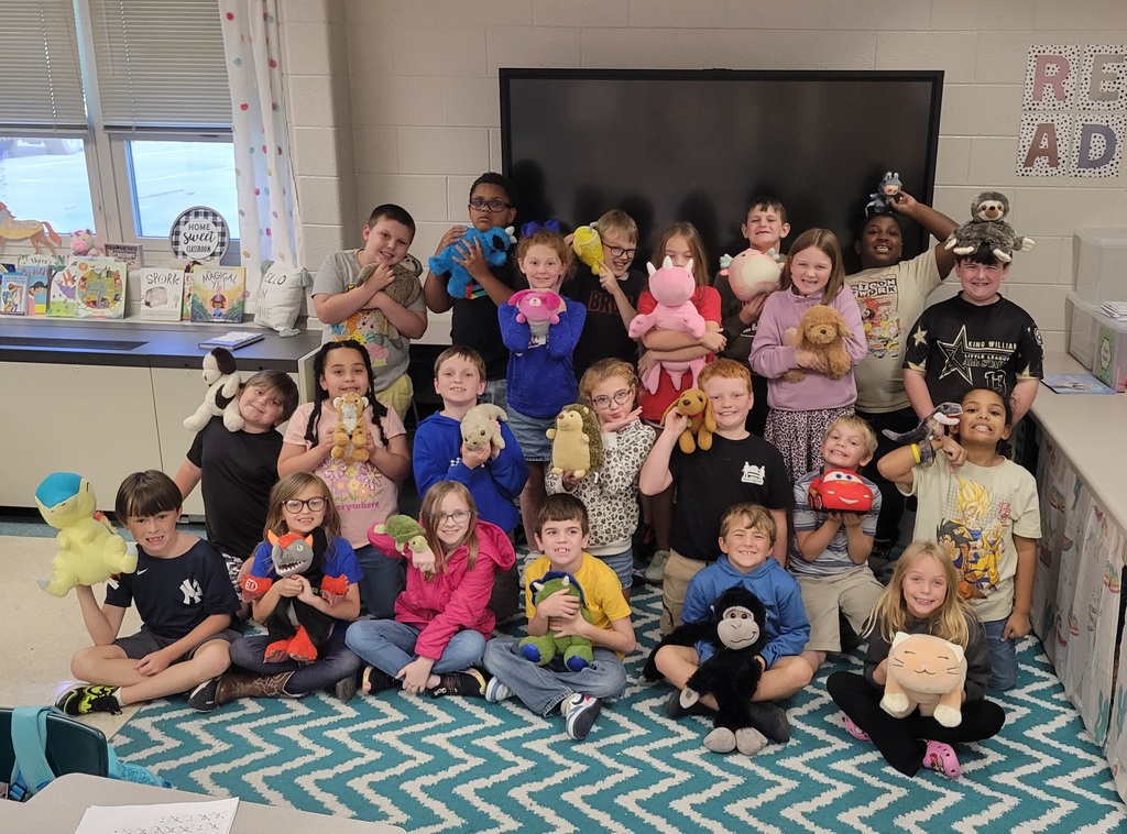 Students holding their stuffed animals