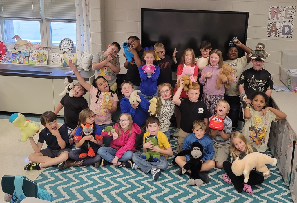 Students holding their stuffed animals