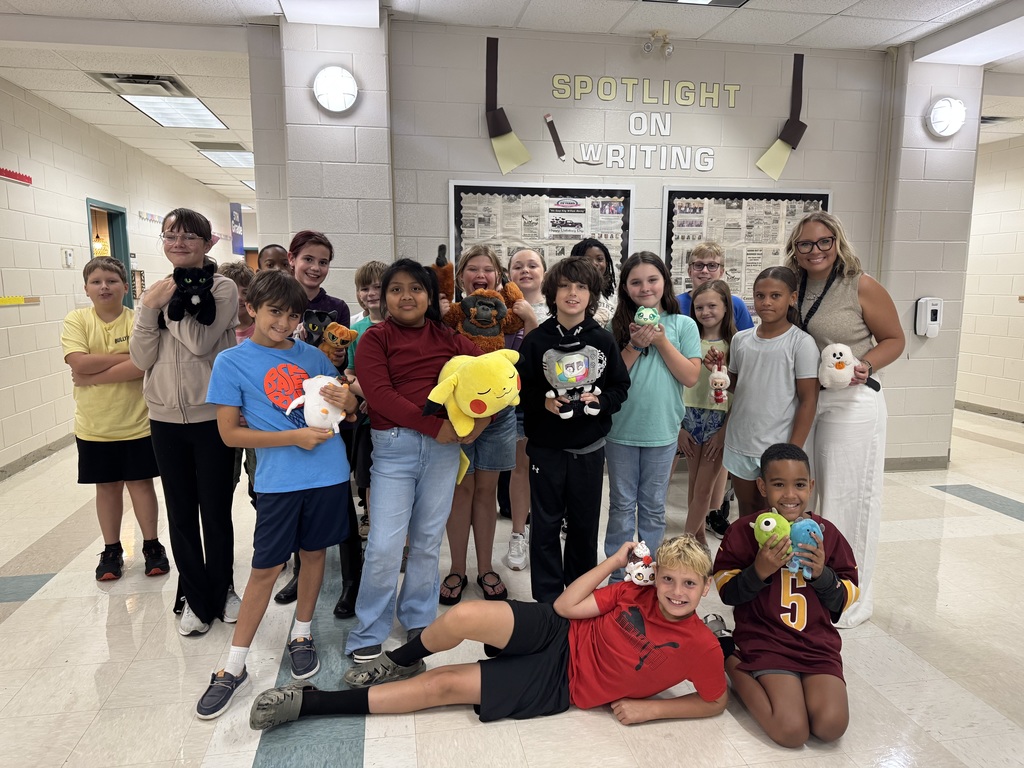 Students holding their stuffed animals