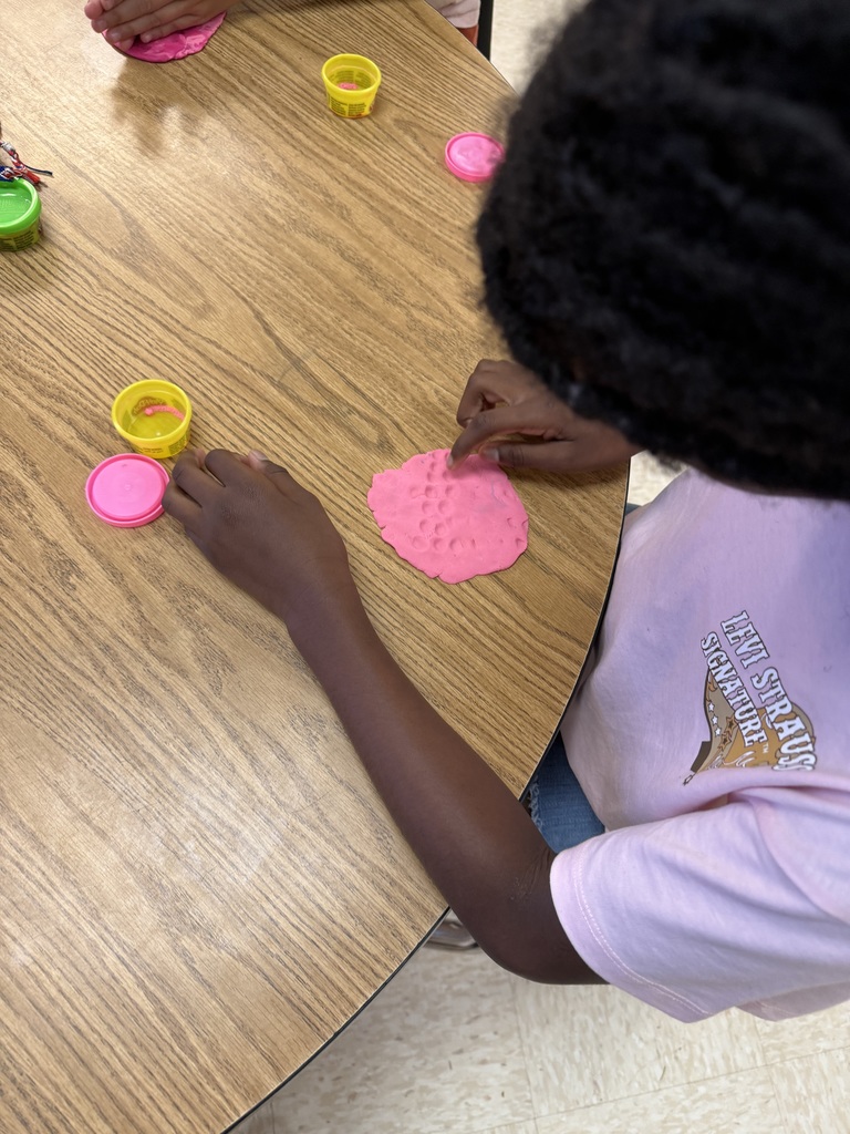 Students practicing multiplication facts using play-doh