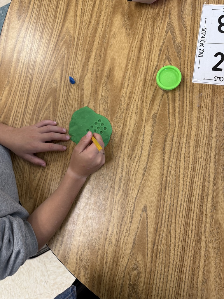 Students practicing multiplication facts using play-doh