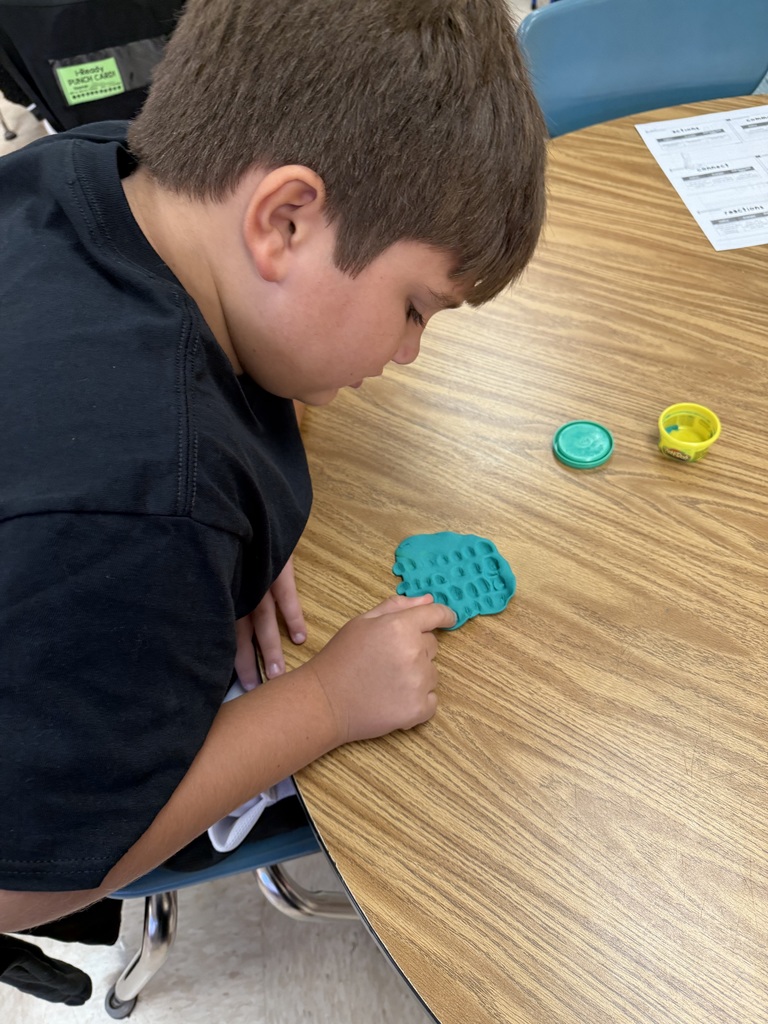 Students practicing multiplication facts using play-doh