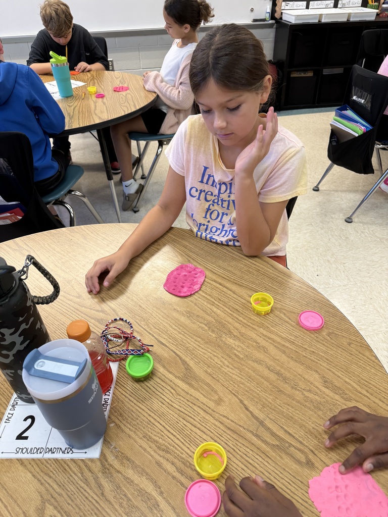 Students practicing multiplication facts using play-doh